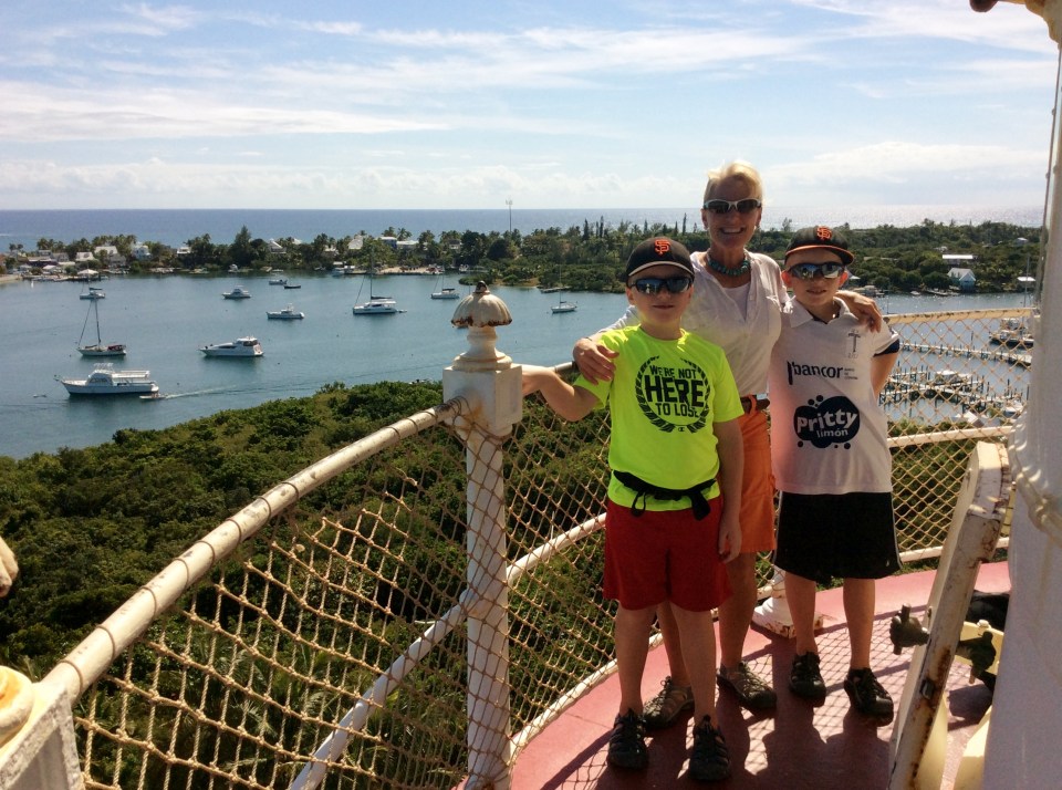 Ronan, Theresa & Ryan atop the Hope Town Light House with the Pilots Discretion in the harbor in the background