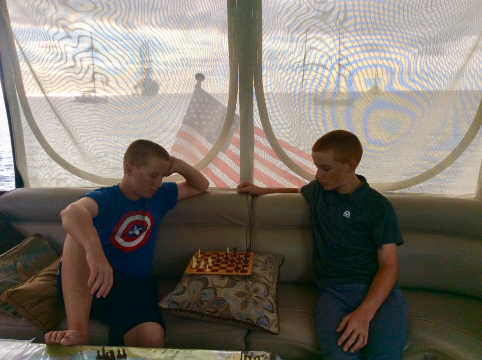 Ronan & Ryan playing chess on the bridge, Sailing Cruise Ship Club Med 2 off our stern, Deshaies, Guadeloupe (2018)